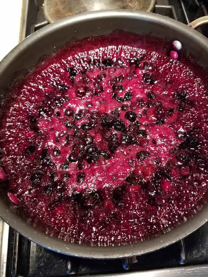 blueberry pie filling cooking in a pan