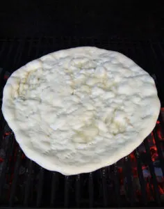 pizza dough on a grill