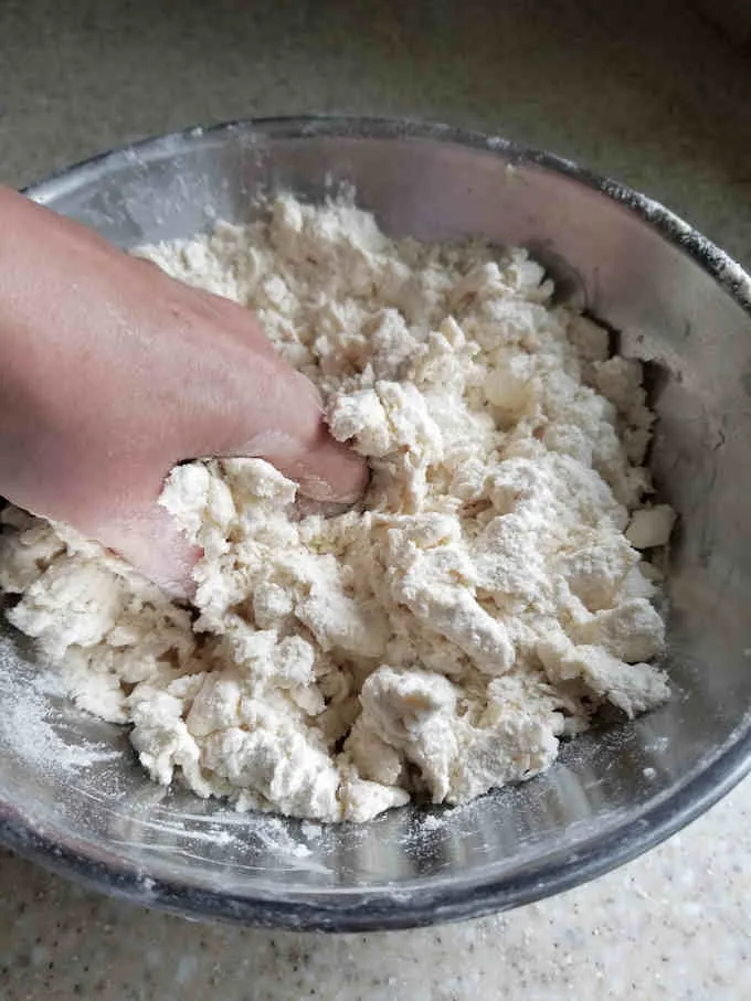 a hand mixing pie dou