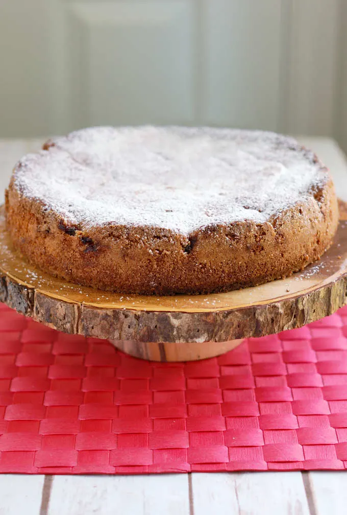 a sour cherry cake on a wooden cake stand