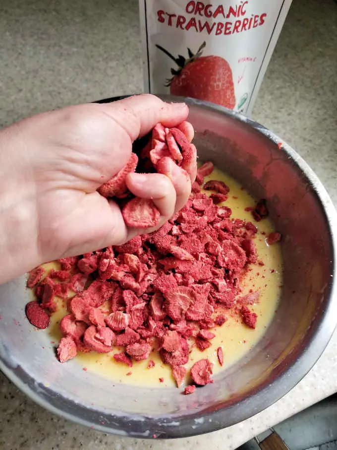 crushing freeze dried strawberries to add to ice cream