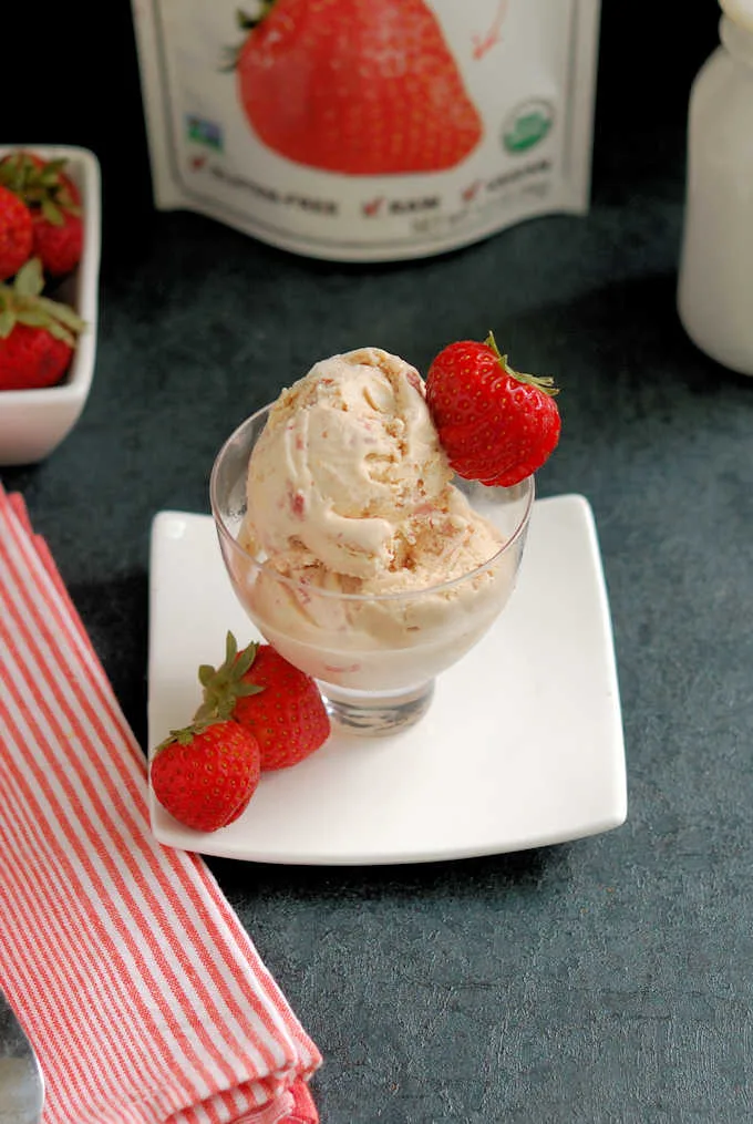 a dish of homemade strawberry ice cream with fresh berries