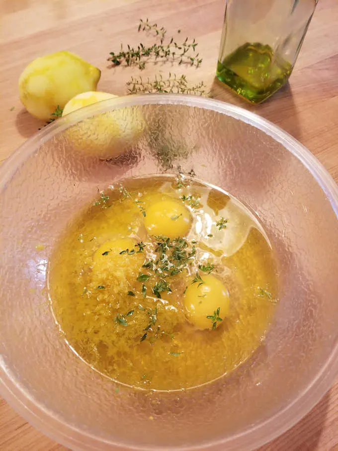 eggs, oil, lemon zest and thyme leaves in a bowl