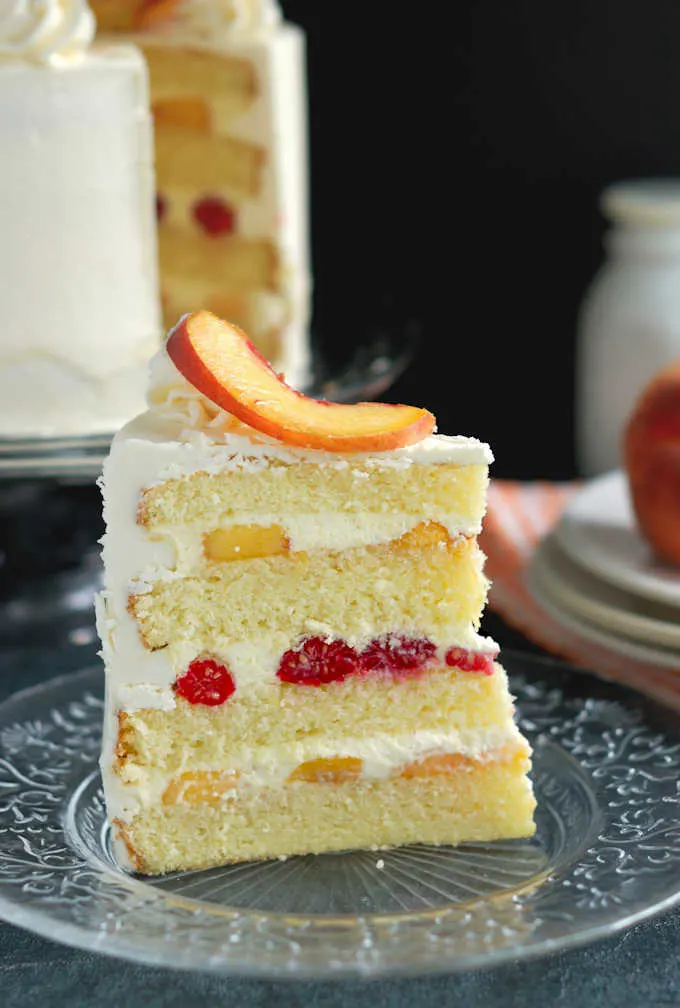 a slice of peach melba cake on a plate