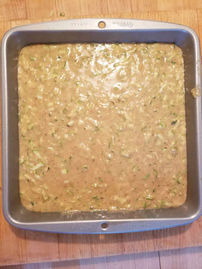 zucchini cake batter in a square cake pan