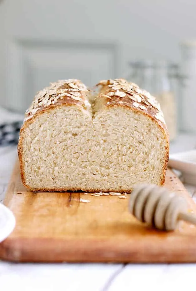 a sliced loaf of oatmeal bread on a cutting board