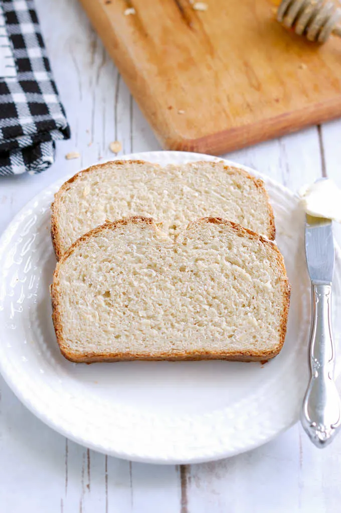 two slices of honey oatmeal bread on a plate