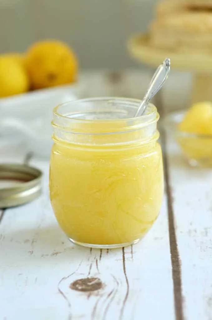 a jar of lemon curd with a spoon in it