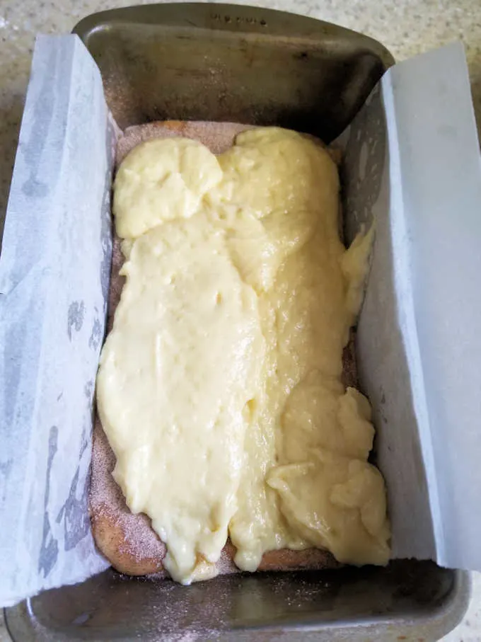 a loaf pan half full with batter