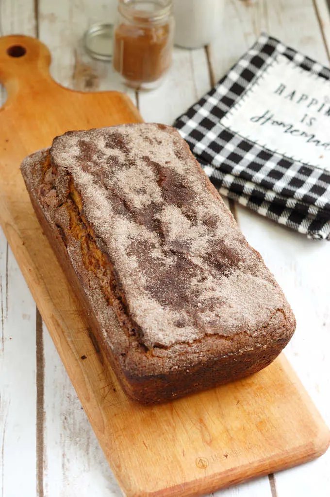 a loaf of snickerdoodle bread on a cutting board