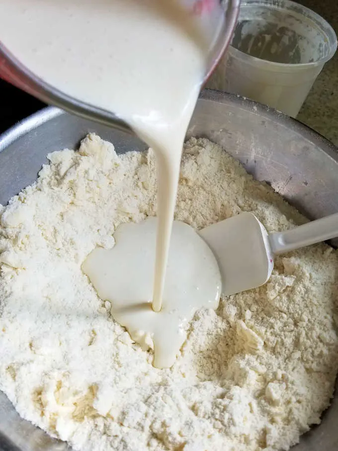 Pouring buttermilk into biscuit mix