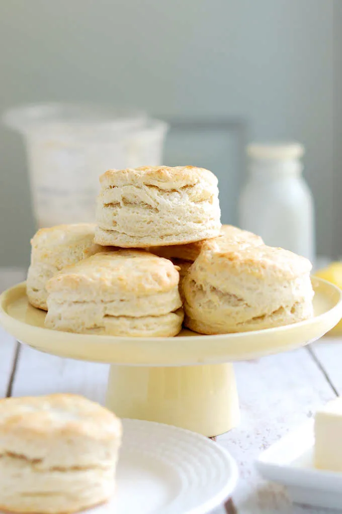 A cake stand stacked with fresh sourdough biscuits