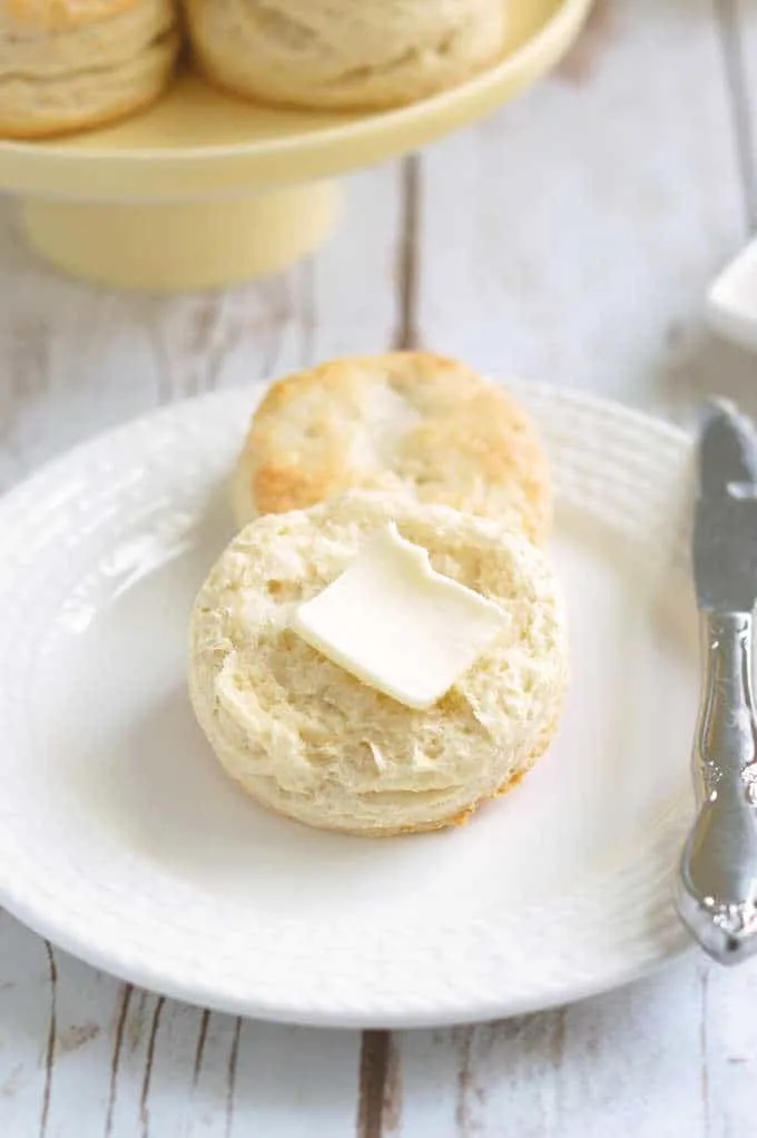 a sourdough biscuit on a plate with a pat of butter