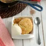 a bowl of apple cobbler with a scoop of ice cream