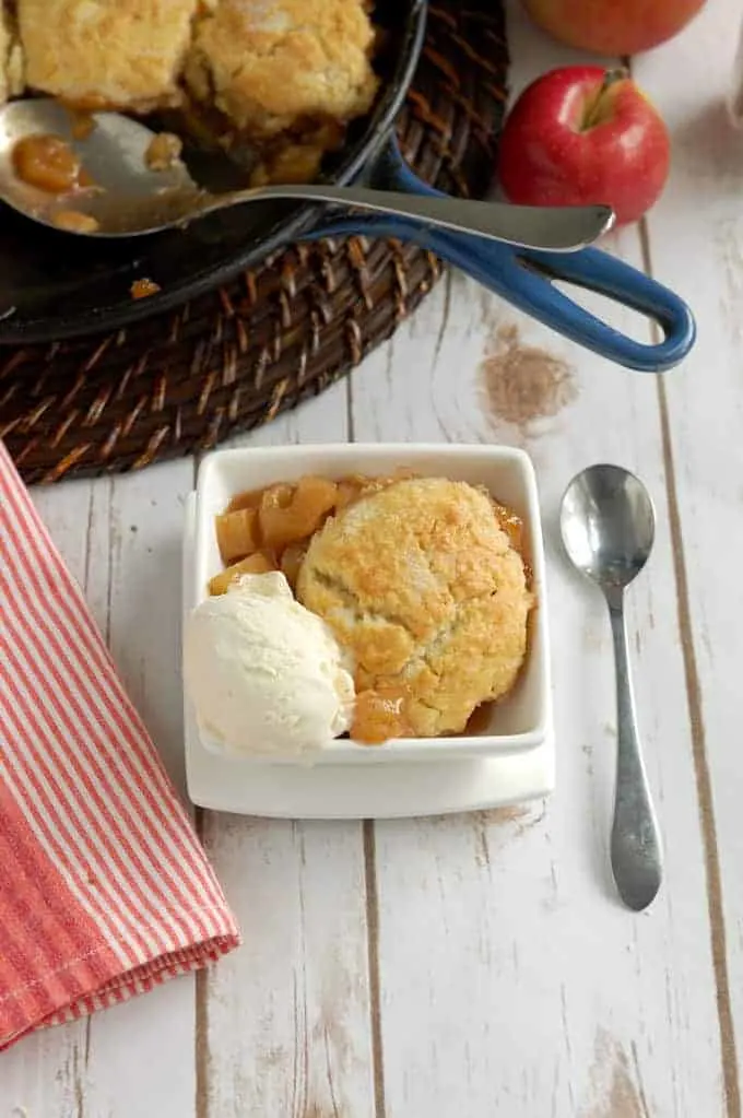 a bowl of apple cobbler with a scoop of ice cream