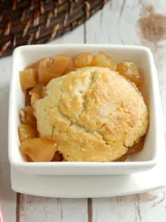 apple cobbler in a white bowl.