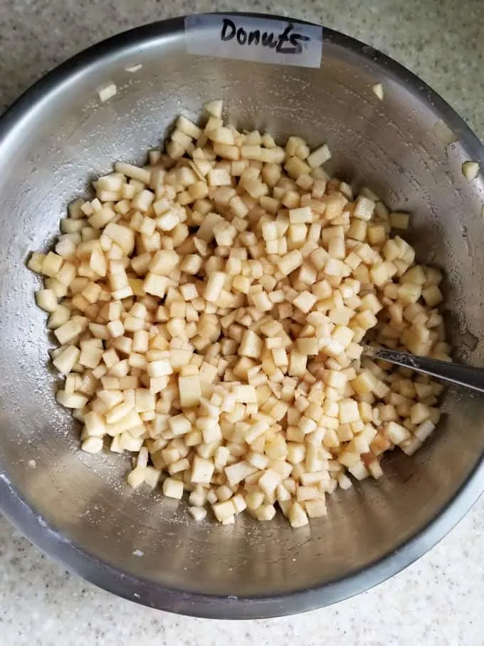 a bowl of chopped apples with sugar.