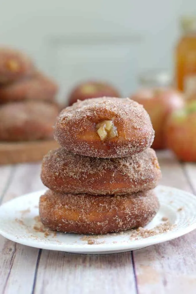 a stack of apple filled cider donuts