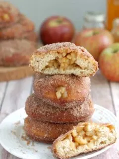 apple filled cider donuts on a plate.