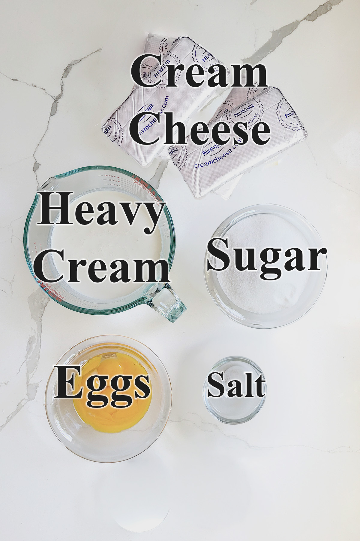 ingredients for basque cheesecake in glass bowls.