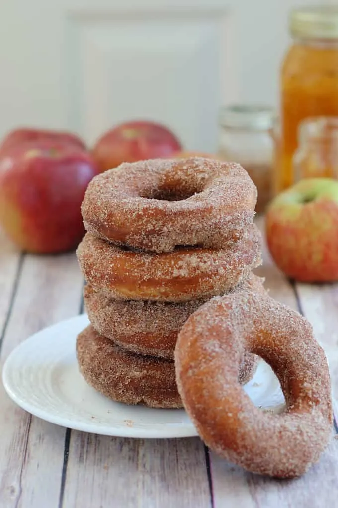 a stack of apple cider donuts on a plate