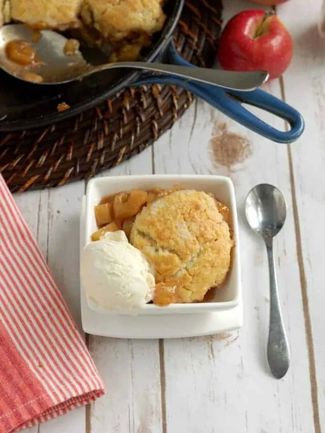 a bowl of apple cobbler with a scoop of ice cream