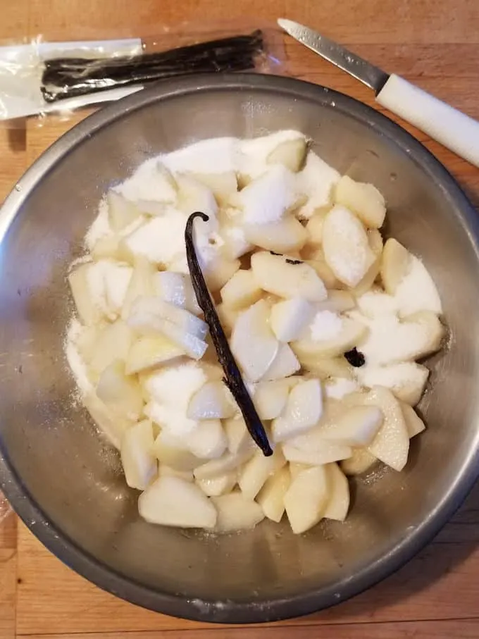 a bowl of chopped pears with sugar and vanilla
