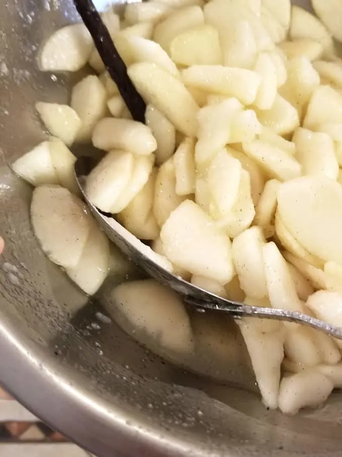 a bowl of macerated pears with juice