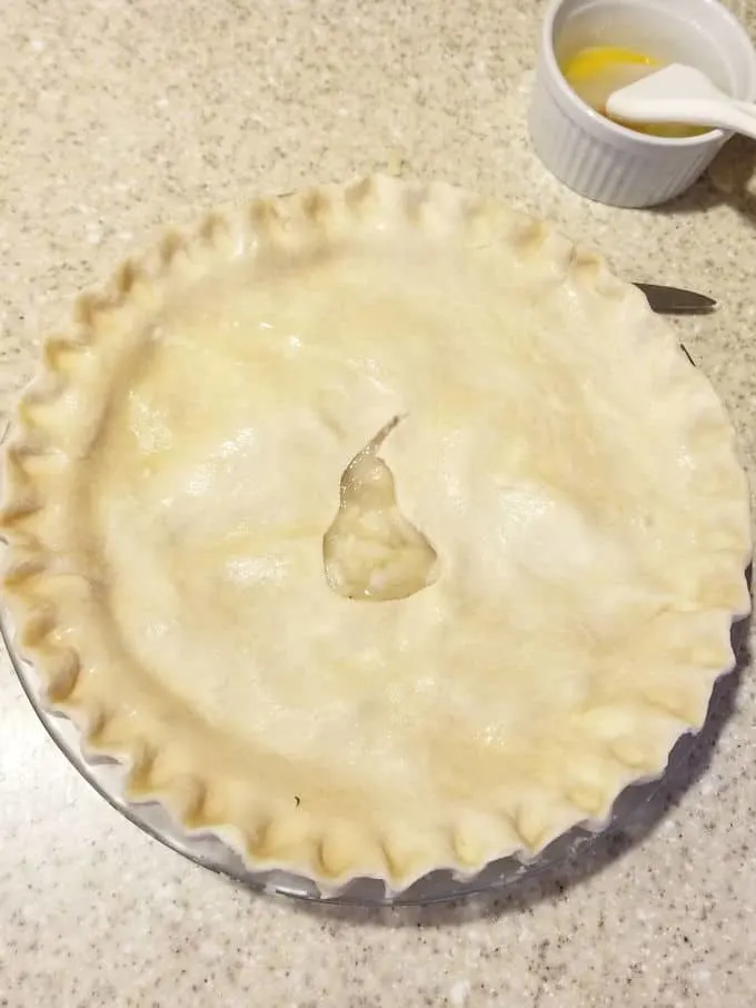 an unbaked pear pie on a countertop.