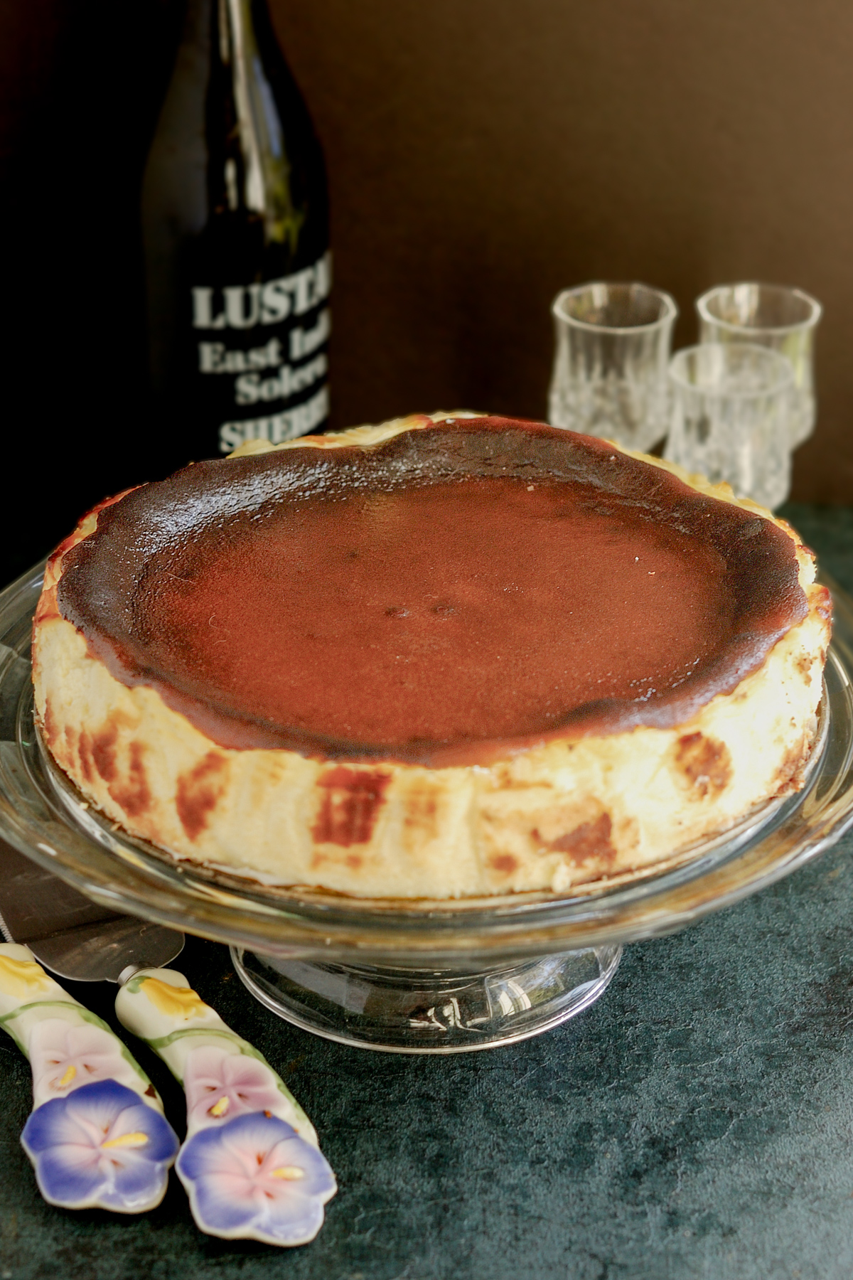 a basque burnt cheesecake on a cake stand.