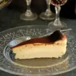 a slice of san sebastian cheesecake on a glass plate