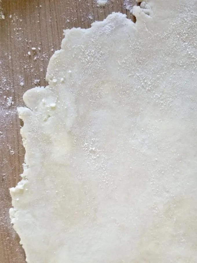 a sheet of dough for sourdough pie crust on a work surface