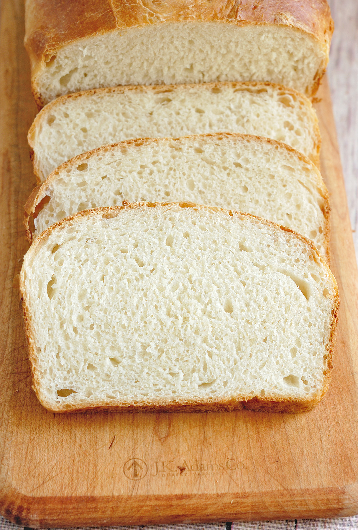 slices of sourdough sandwich bread on a cutting board.