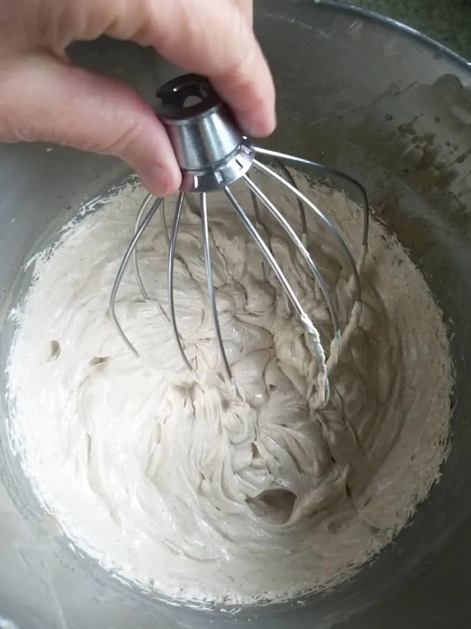 a bowl of whipped ganache with a whisk