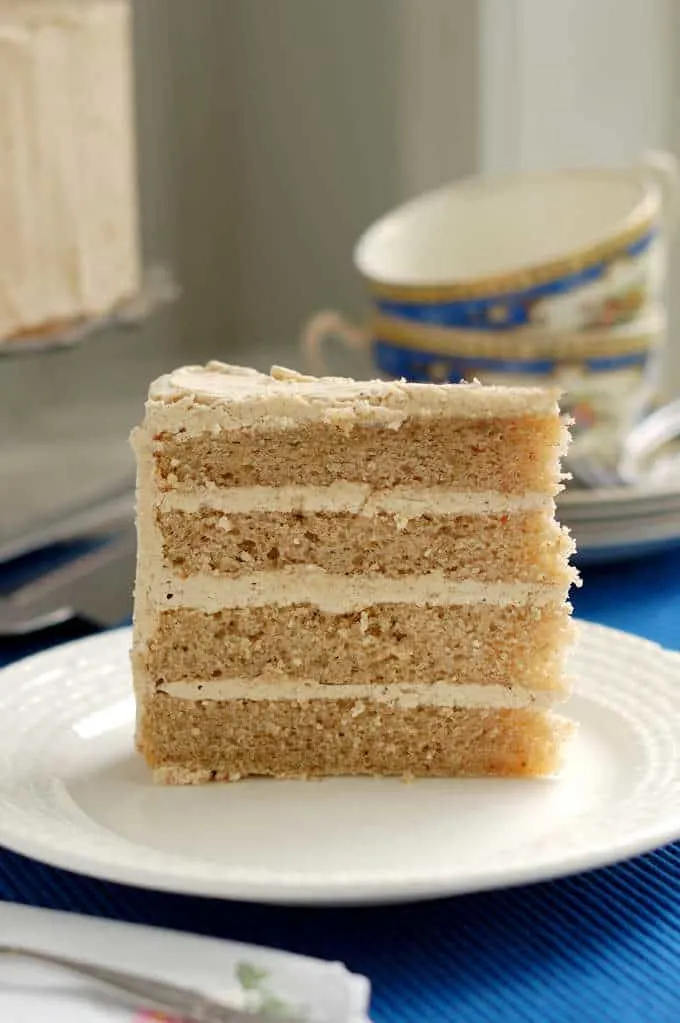 a slice of 4 layer spice cake with spiced ganache on a plate