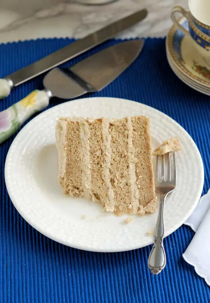 a slice of spice cake on a plate with a fork