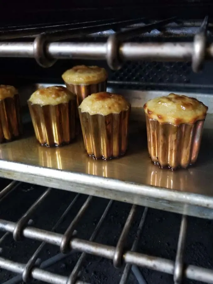 caneles baking in a hot oven
