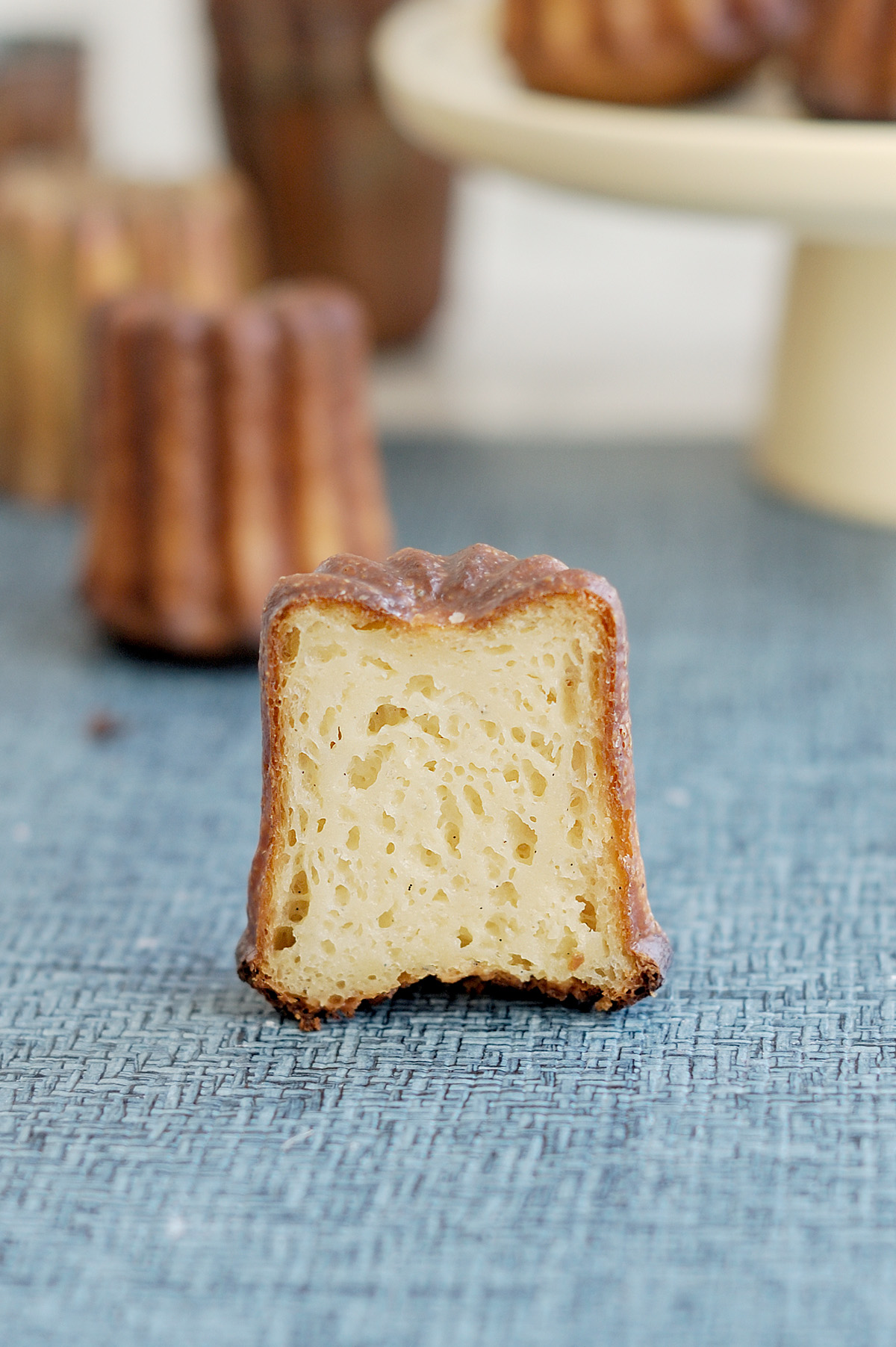 a perfect french canele split to show interior crumb.