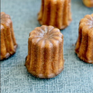 caneles on a blue surface