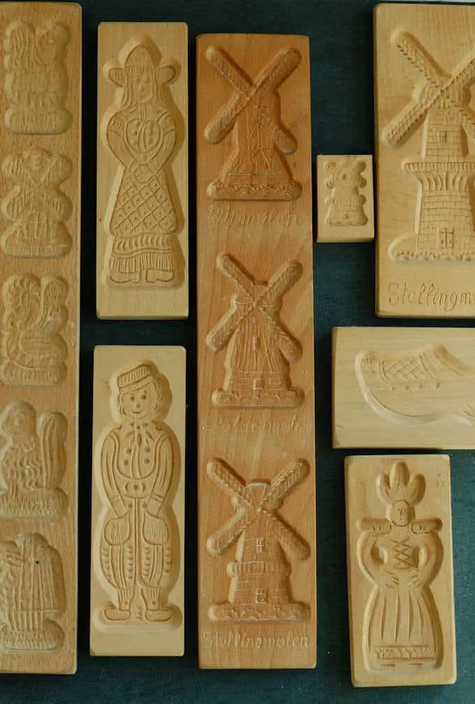 a collection of wooden speculaas cookie molds on a black background