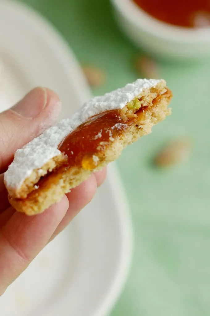 showing the interior crumb of a pistachio apricot linzer cookie