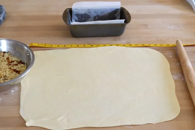 a sheet of bread dough rolled out, ready to cut and layer to make pull apart bread