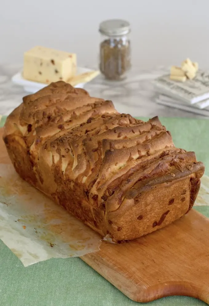 a loaf of bacon and pepper jack pull apart bread on a cutting board