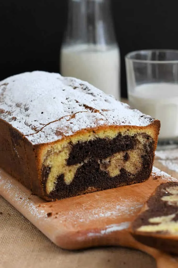 a sliced marble pound cake on a cutting board