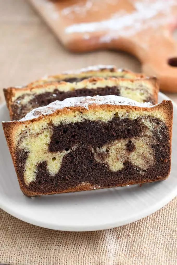 a slice of marble pounds cake on a plate