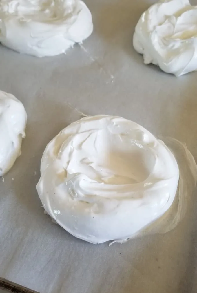 individual pavlovas on a tray ready to bake