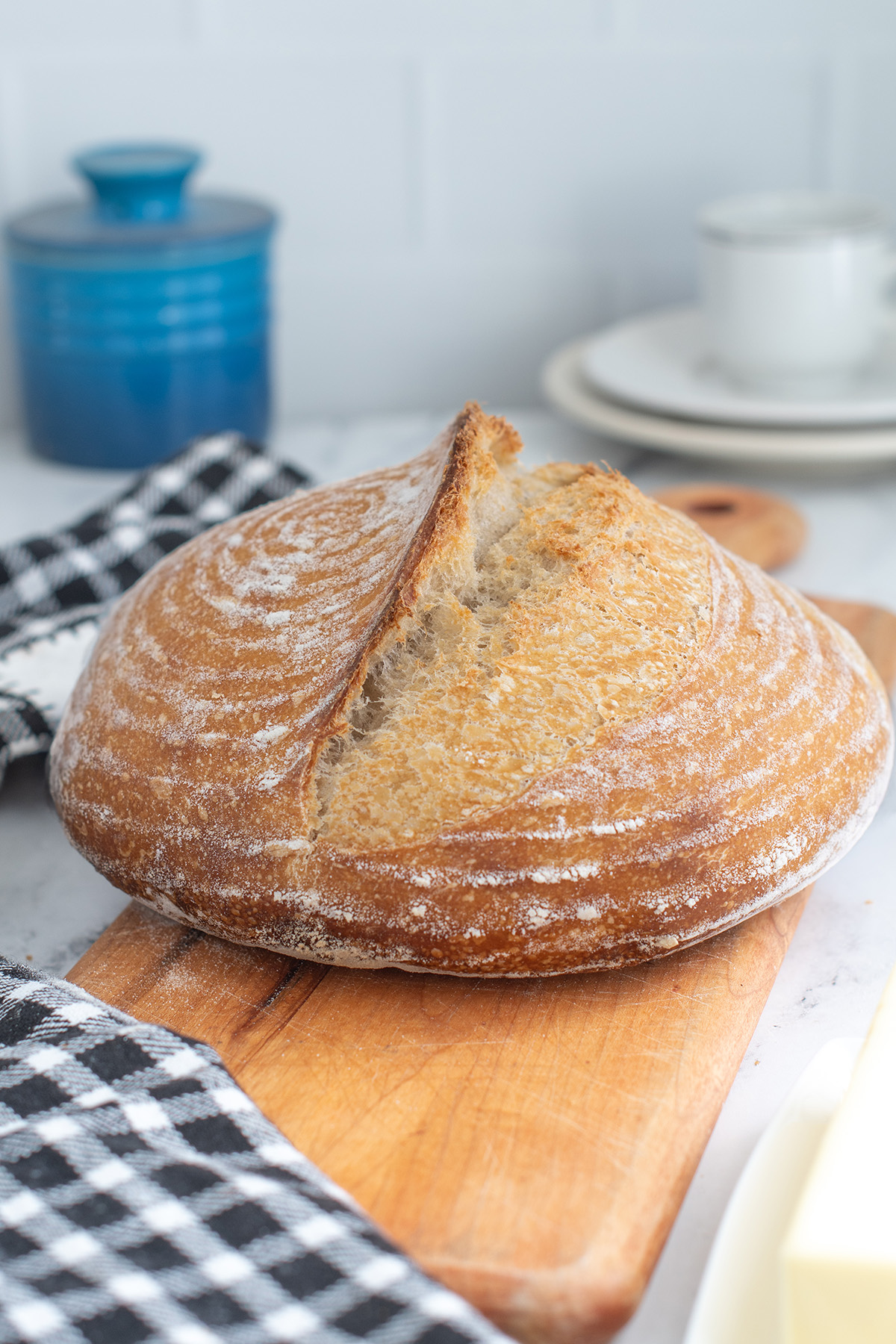 a loaf of sourdough bread on a cutting board.