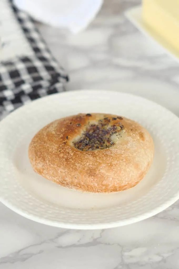 a sourdough bialy on a white plate