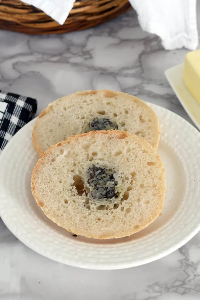 a slice sourdough bialy on a plate showing the interior crumb