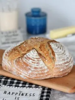 a loaf of sourdough bread on a cutting board